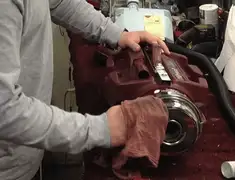 Vacuum repair technician cleaning and servicing a vacuum motor in Grand Rapids, MI
